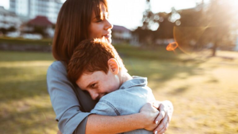A woman hugs her son