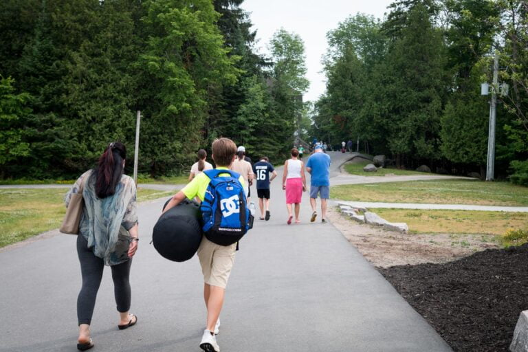people walking towards cabins