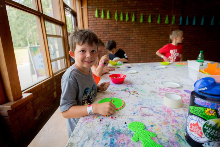 A Young boy smiling at a table