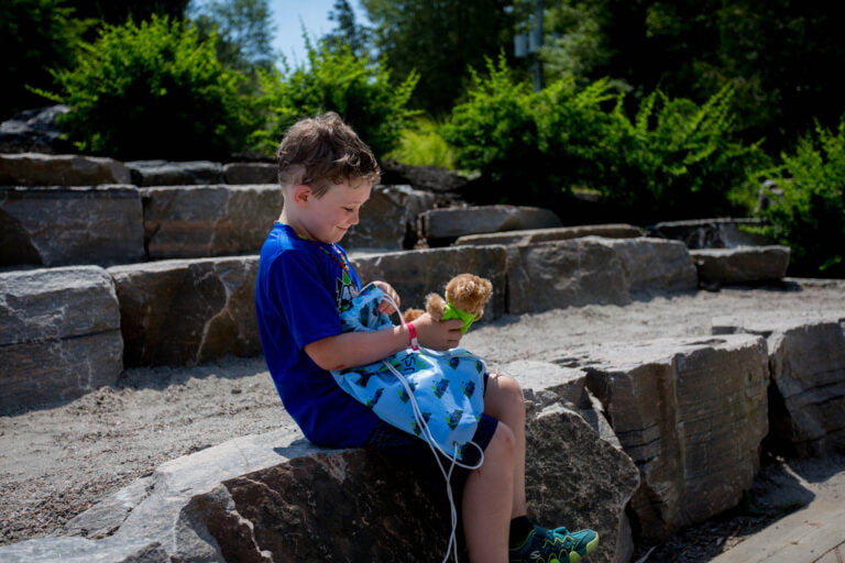 A young boy looks through a bag with toys