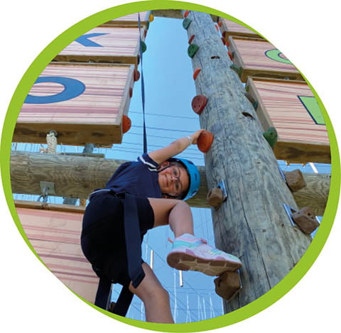 a young person climbing a pole