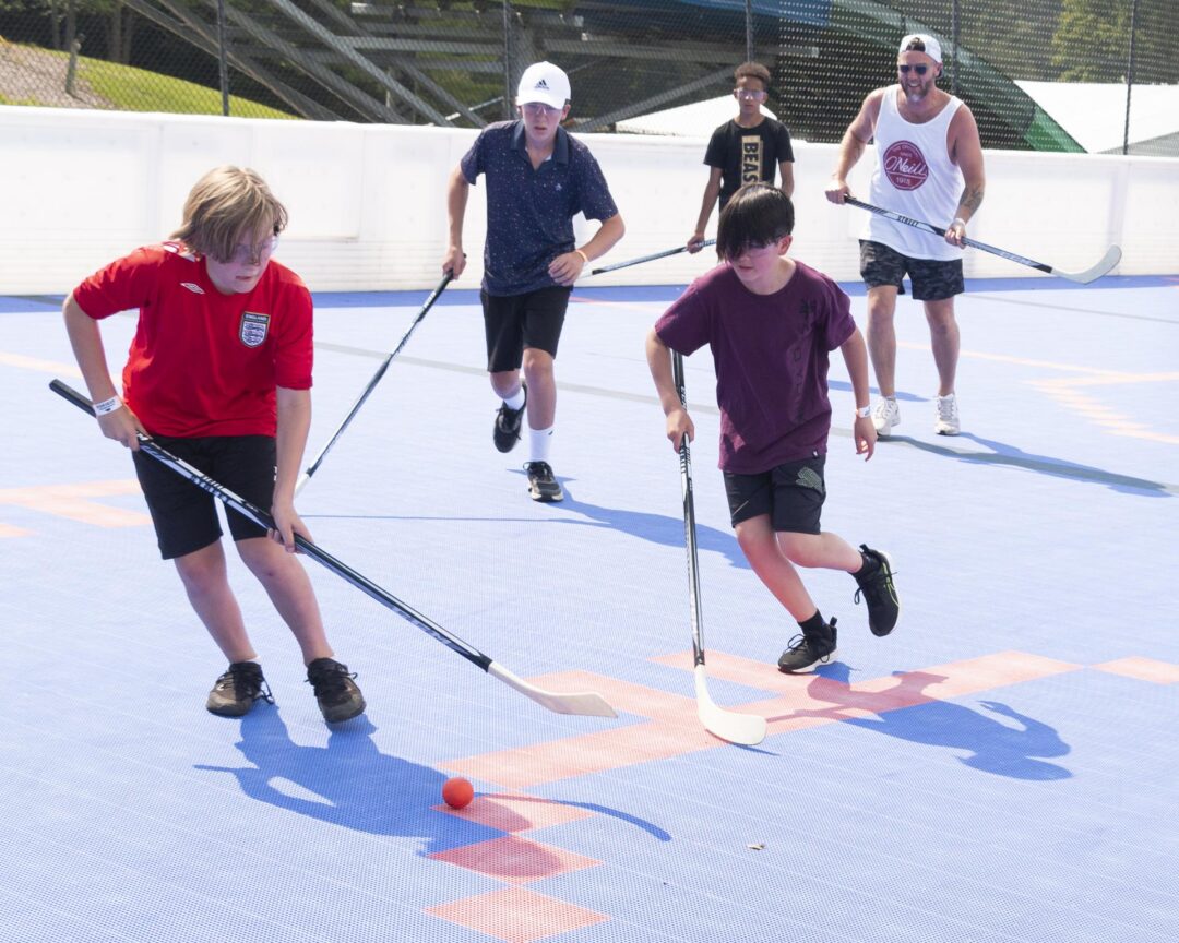 boys playing ball hockey outside at Muskoka Woods