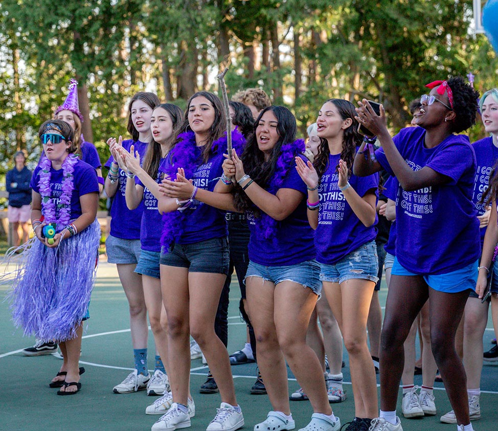 kids in purple shirts clapping