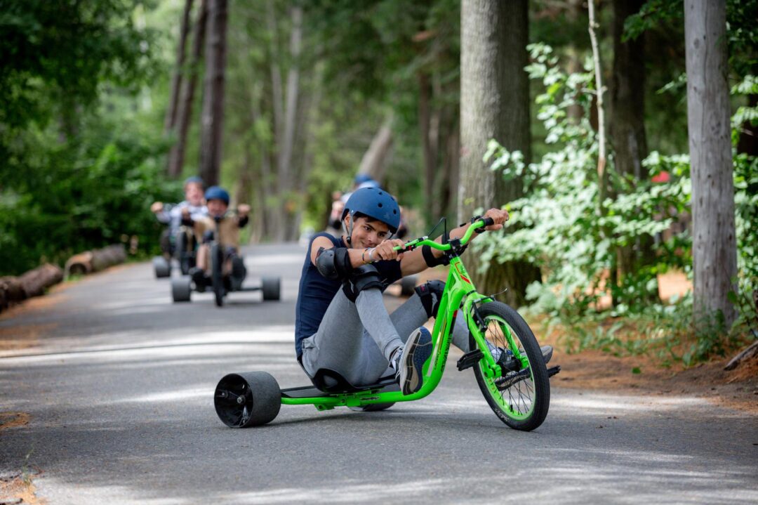a teenaged boy riding a drift trike